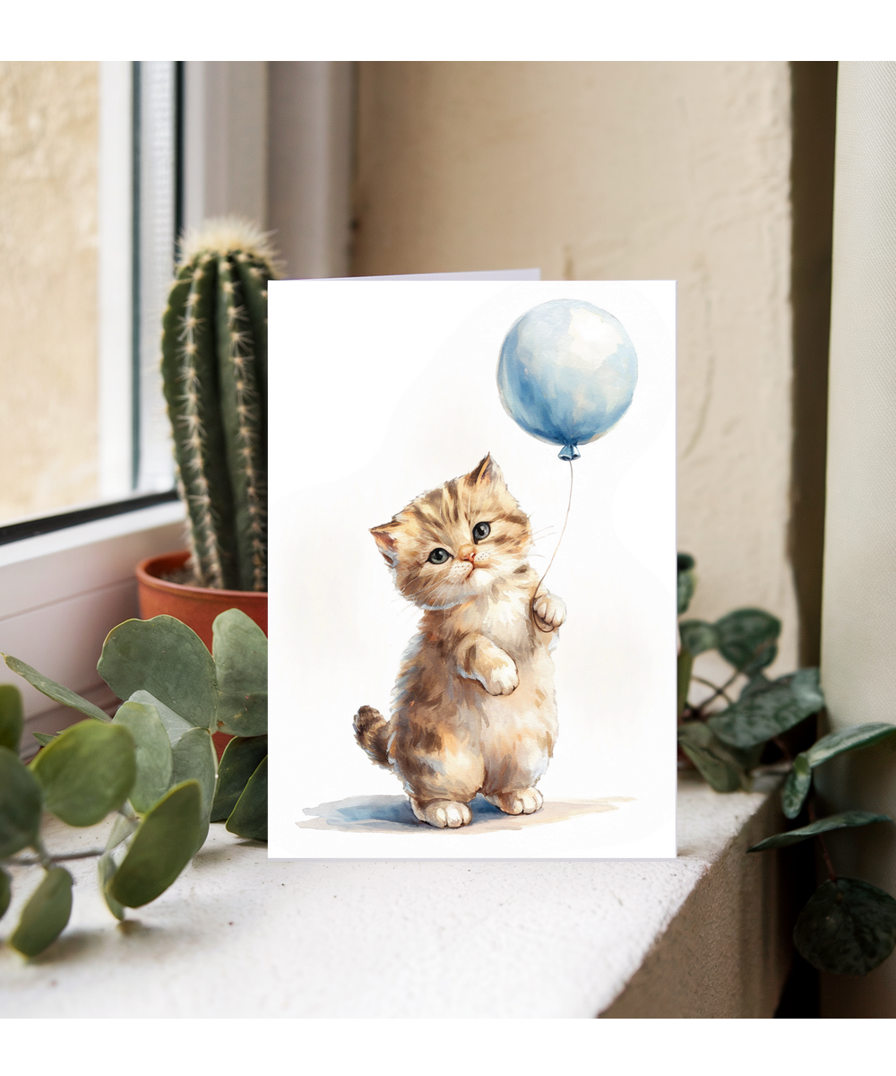 Kitten with a blue balloon