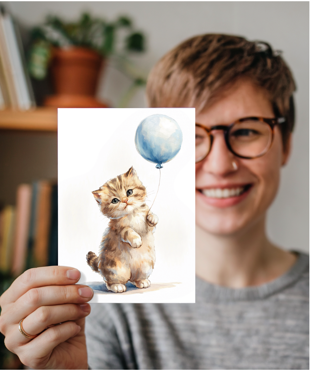 Kitten with a blue balloon